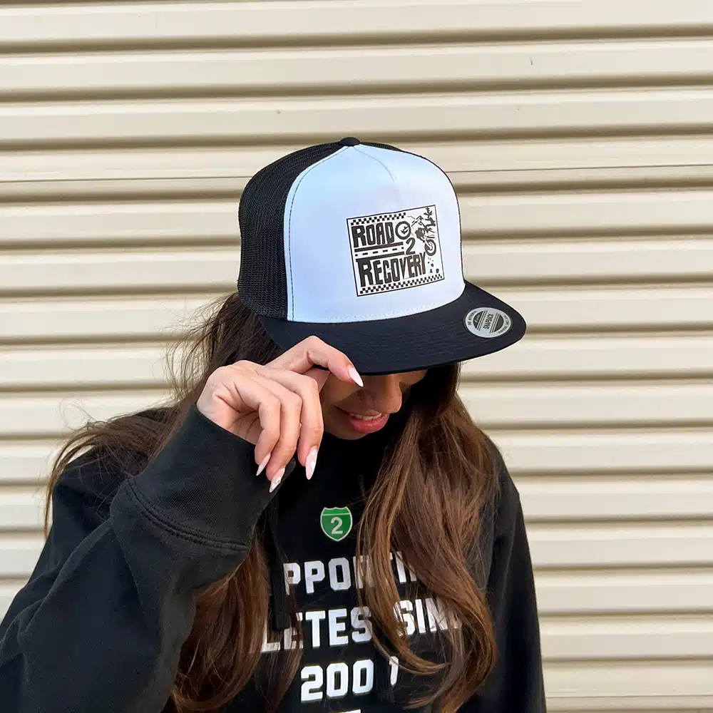 Female model wearing the Moto R2R Trucker Hat