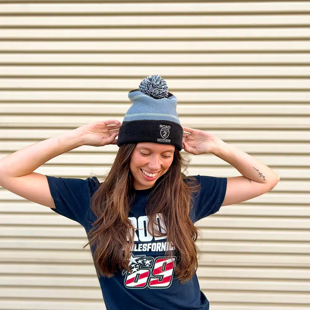 Model wearing Tri-Tone Striped Pom Beanie