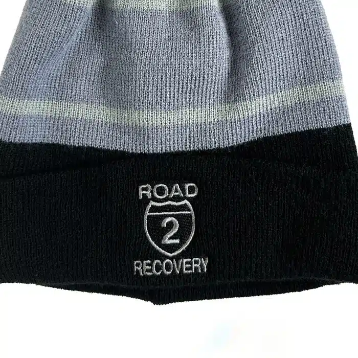 Close-up of Tri-Tone Striped Pom Beanie