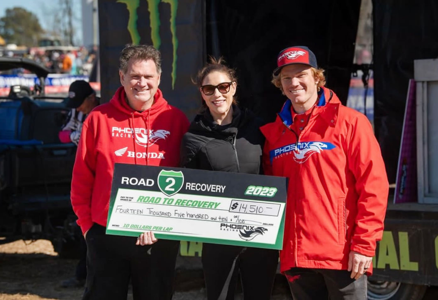 Phoenix Racing Team presenting donation check to Road to Recovery team